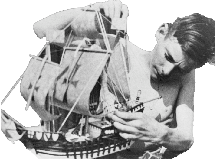 Young boy making a model sailing ship