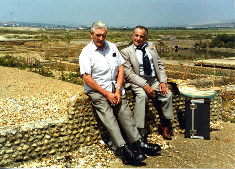 Two men, former patients of the hospital, sitting on a crumbled wall at the ruins of Tide Mills.
